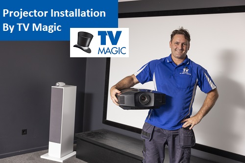 Technician holding a projector. Caption "Projector Installation by TV Magic"