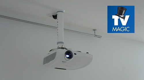 A small projector installation with TV Magic logo in top right corner