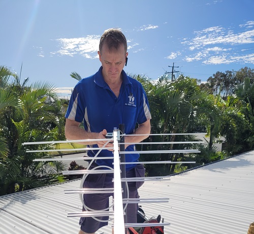 Technician holding an antenna testing signal