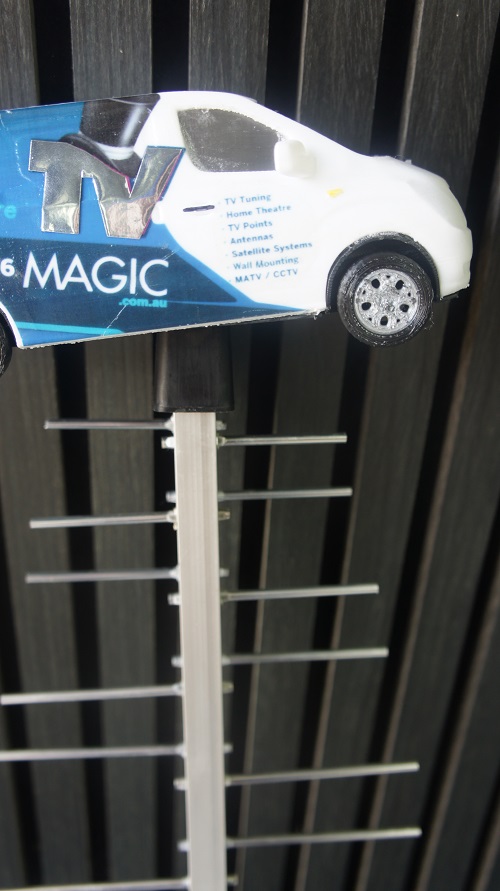 A mini TV Magic van on top of a TV Magic antenna