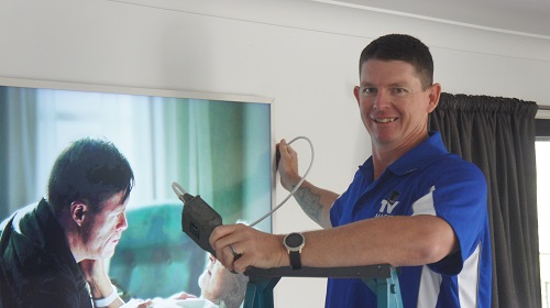 Technician - Brendan, setting up and tuning a large TV