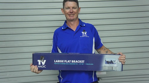 Technician - Brendan, holding a wall bracket