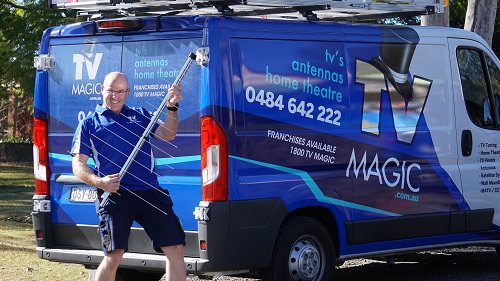 Technician - Carl, at the back of his van holding an aerial.