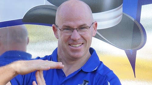 Technician Carl, making a T with his hands.