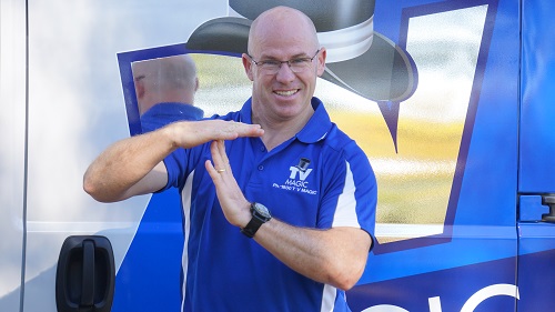 Technician Carl - Making a T for TV Magic with his hands.