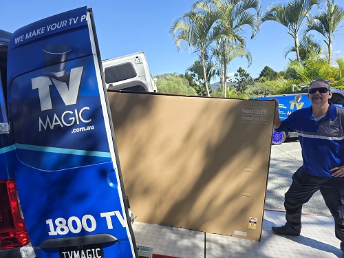 Large TV being loaded into TV Magic van