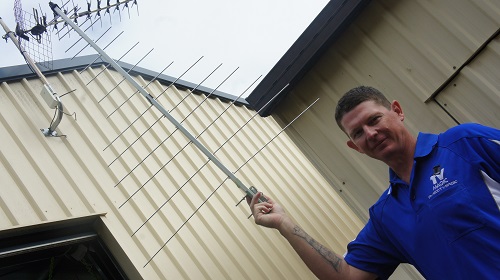 Technician holding up an aerial