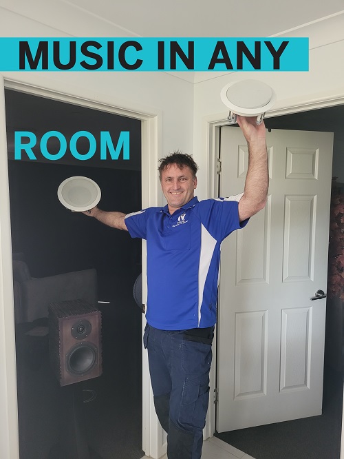 Technician holding up speakers. Caption "Music in Any Room"