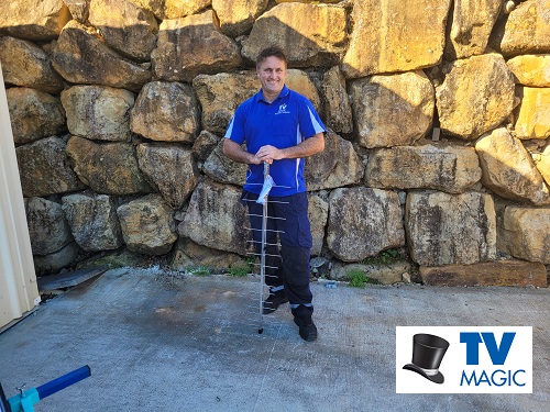Technician standing with a TV Magic antenna