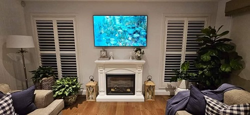A complete TV setup - wall mounted TV above fireplace