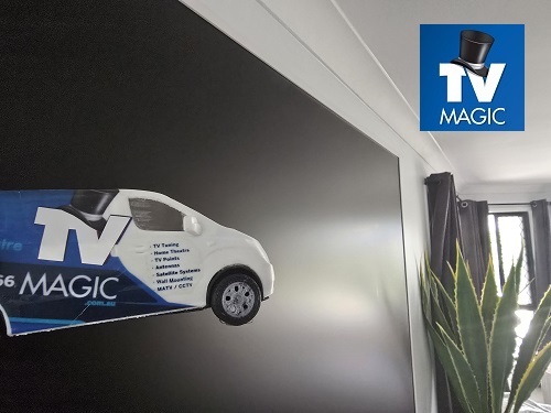 Mini TV Magic van in front of a wall mounted TV