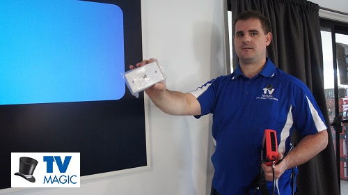 Technician next to large TV with TV point in hand. Logo bottom left