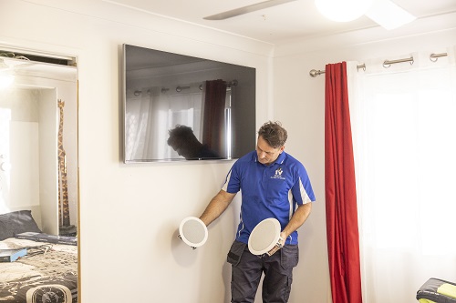 Technician preparing for a multi-room audio installation in Point Grey