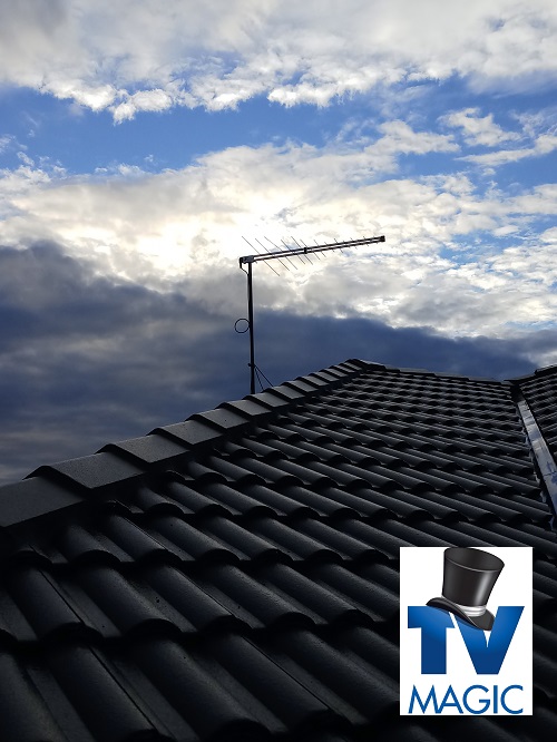 A TV Magic antenna on a tile roof