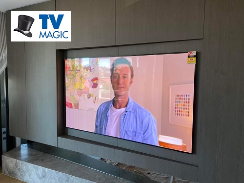 Wall mounted TV by TV Magic. Logo in top left corner