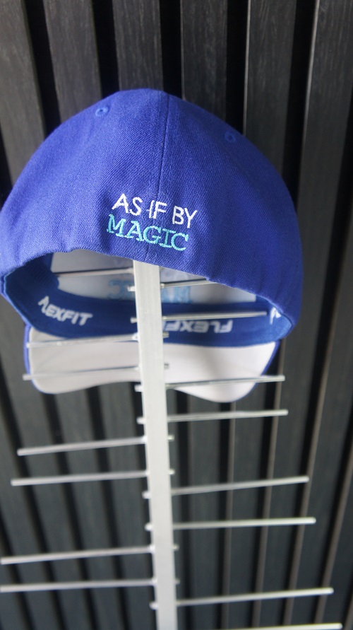 A TV antenna with a TV Magic cap on top that says "As If By Magic"
