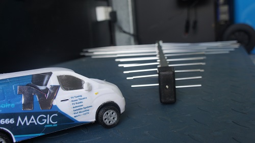 An antenna close up with a mini TV Magic van