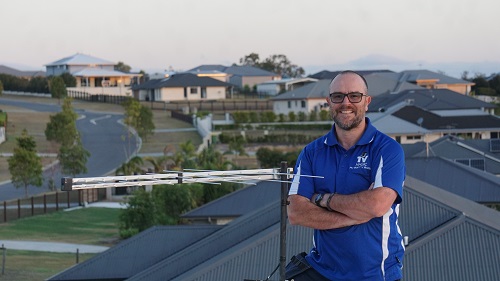 Technician next to an antenna he relocated.