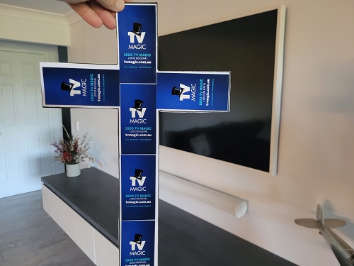 Large TV behind Cross comprised of TV Magic stickers