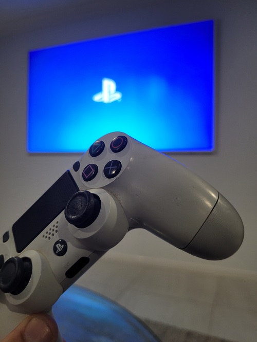 Gaming controller in front of large screen