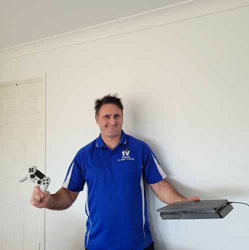 Technician holding a gaming console and controller