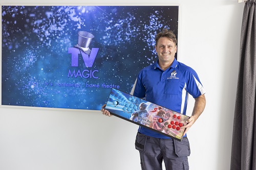 Technician holding a gaming console ready for setup