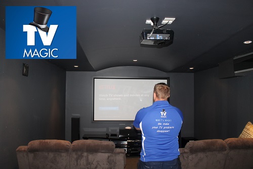 Technician - Keith in a home cinema he designed.