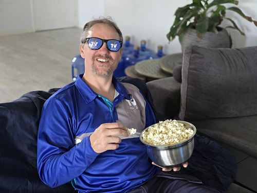 Technician eating popcorn, wearing TV Magic sunglasses