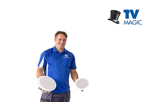 Technician holding 2 speakers. Logo in top right corner