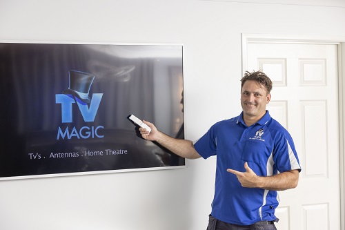 Technician holding a remote up to a Samsung Frame he installed