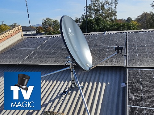 close up of a satellite dish installation on a tin roof. TV Magic logo in bottom left corner
