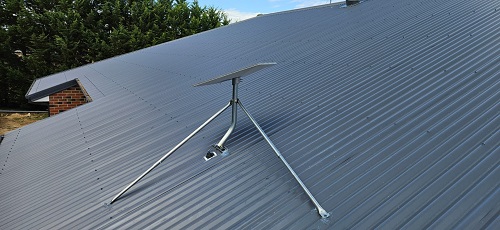 A Starlink internet installation on a tin roof.