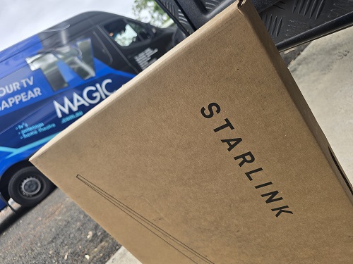Starlink kit in front of TV Magic van