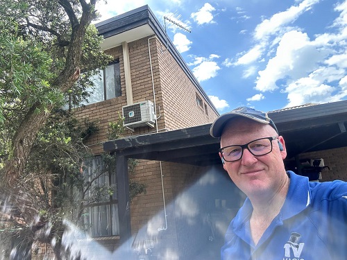 Technician Craig with an antenna he installed.