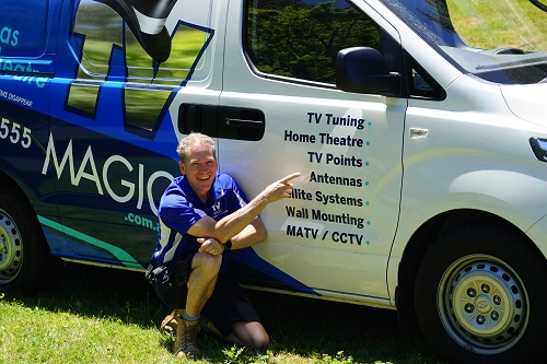 technician - Robert, crouched next to his van, pointing at his services menu