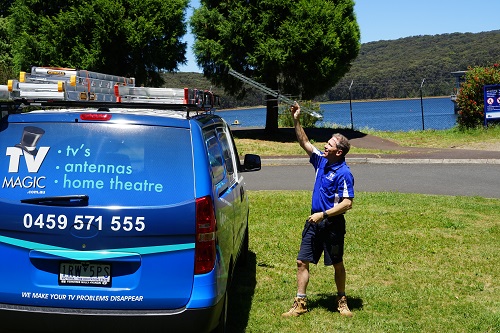 Technician - Robert, holding up an antenna
