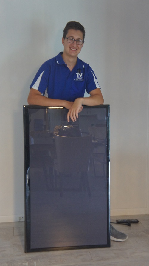 Technician - Keith, with a broken TV