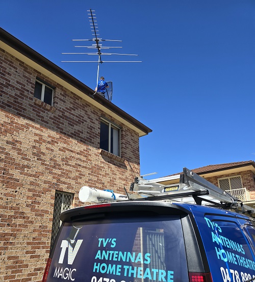 Technician - Craig, performing a TV reception repair for a customer