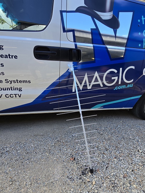 Antenna leaning on side of TV Magic van