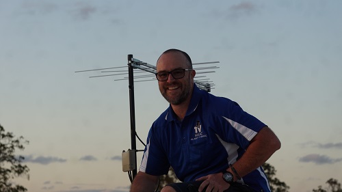 Technician with an antenna he repaired