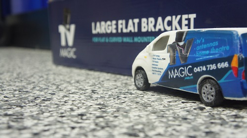 Mini TV Magic van in front of a TV Magic wall bracket.