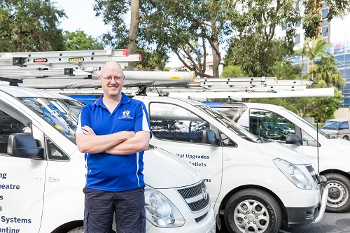 Technician - Craig, standing in front of his vans