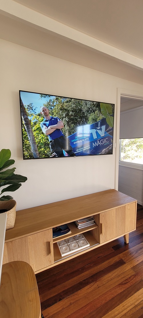 A TV on a living room wall.