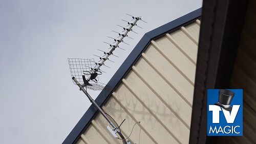 an antenna on a tin roof with a TV Magic logo