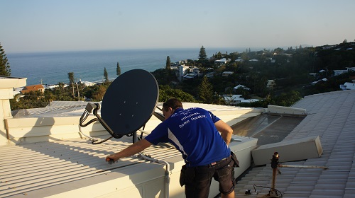 Technician installing a satellite dish
