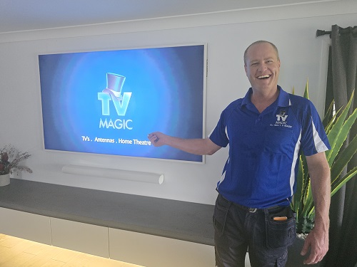 Technician with a TV he installed