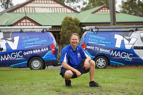 Technician in front of his two vans.