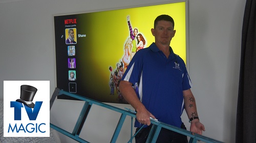 Technician in front of a TV he relocated