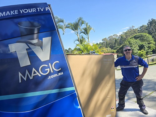 Technician Jason moving a large TV