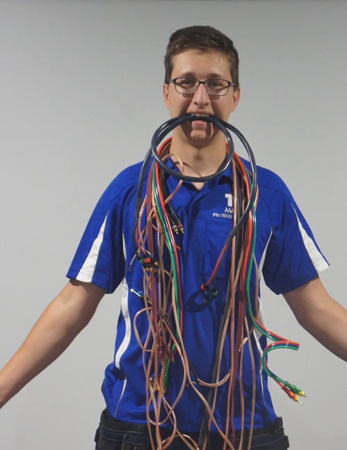 Technician with spaghetti cables handing from his mouth